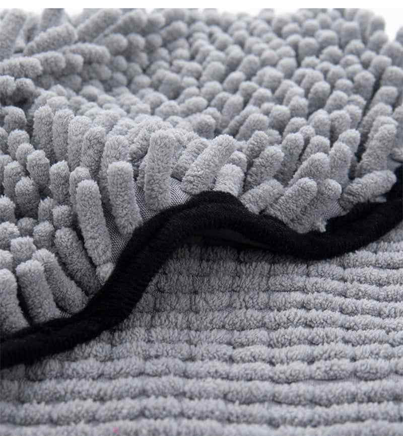 Close-up of Petra store Super Absorbent Pets Bathrobe fabric showing gray soft textured microfiber material with black trim