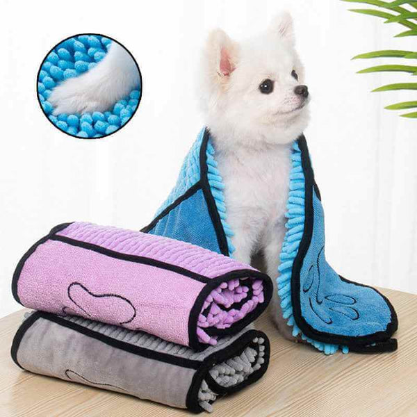 Super Absorbent Pets Bathrobe in blue worn by small white dog with extra bathrobes in purple and gray