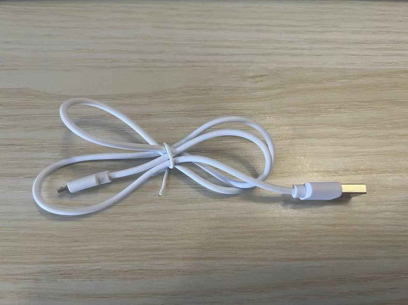 White USB charging cable for Thermal Neck Lifting And Massager from Petra store on wooden surface