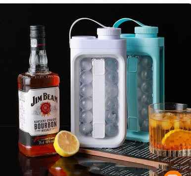 Petra store portable ice ball maker kettle duo in white and teal next to whiskey bottle glass and lemon slice
