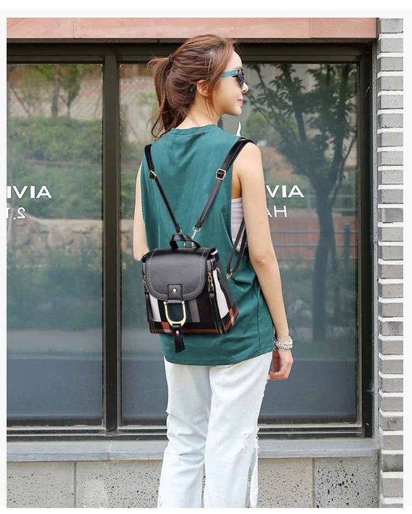 Petra store stylish bag for women small black leather backpack with buckle adjustable straps worn by model