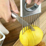Petra store Stainless Steel Vegetable Holder and Slicer used to safely cut a yellow fruit on wooden board
