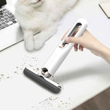 Petra store mini cleaning mop in white used to clean crumbs on a white desk near a fluffy white cat