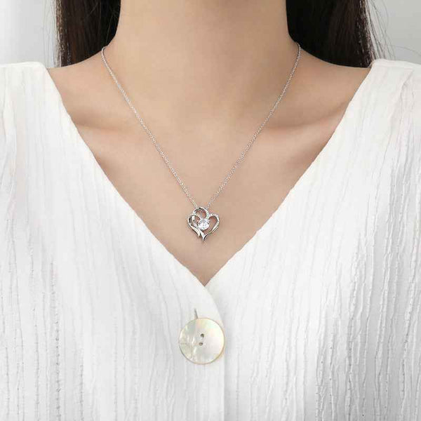Zircon Double Love Necklace with heart-shaped pendant on silver chain worn with white top