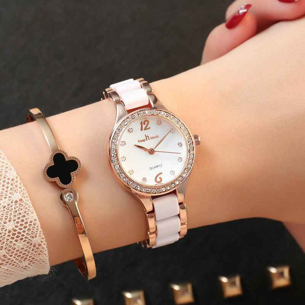 Women's Luxury Quartz Watch with rose gold and white band and crystal accents on wrist
