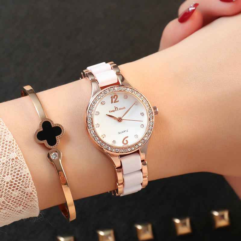 Women's Luxury Quartz Watch with rose gold and white band and crystal accents on wrist