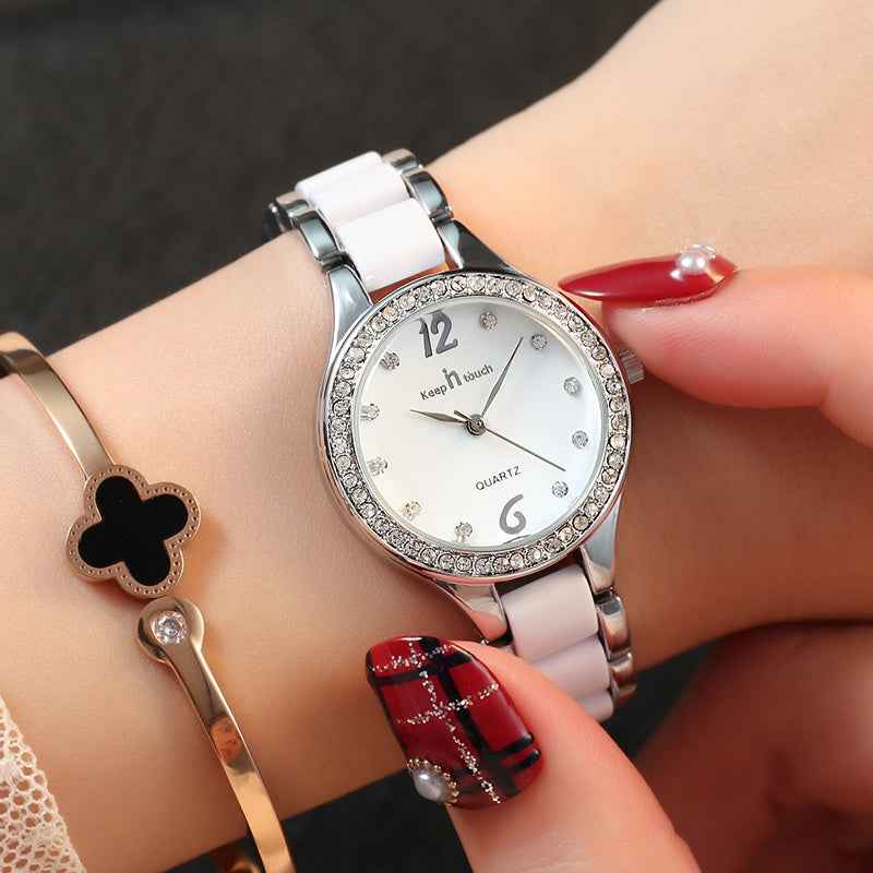 Petra store Women's Luxury Quartz Watch with silver and white band and crystal accents on wrist